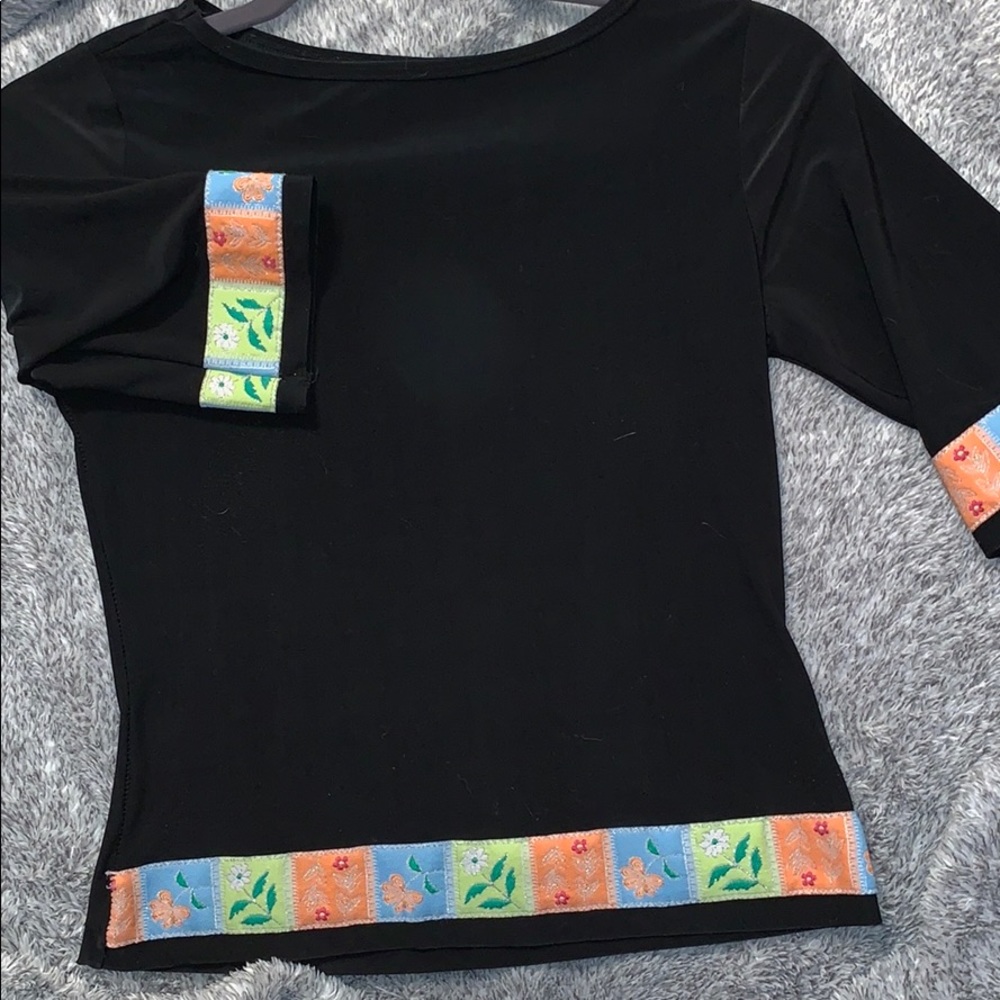 Black it’s color shirt on the sleeves.